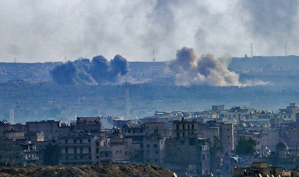 A general view taken from the government-held side of Aleppo shows smoke billowing from the Sheikh Said district during battle between regime forces and rebel fighters on December 3, 2016.