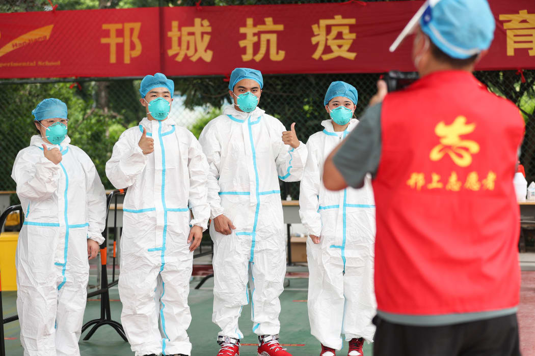 Local citizens line up while keeping social distance at a test center in Gaoxin District of Yangzhou City, east China's Jiangsu Province, 11 August 2021.
