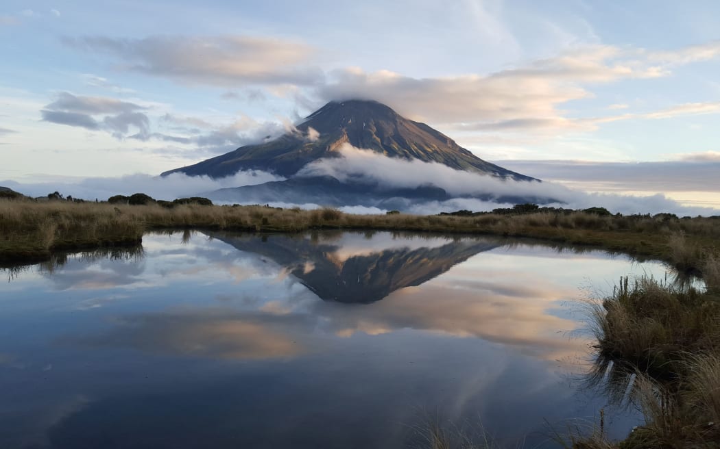 The view of Mt Taranaki reflected in the tarns on the Pouakai saddle.