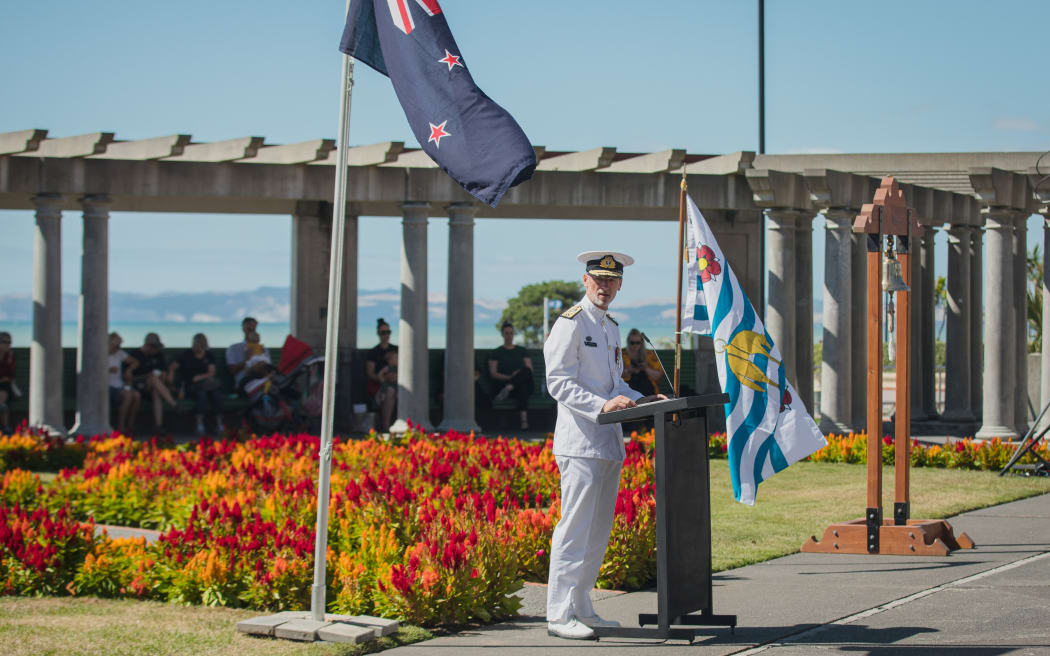 Commodore Mathew Williams, Royal New Zealand Navy Maritime Component Commander with the Veronica bell in the background.