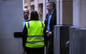 Former Jetstar pilot Greg Lynn (R) is led from court in Melbourne on June 25, 2024 after he was found guilty by a jury of murdering retiree Carol Clay at a Victorian campsite in March 2020, but was found not guilty of murdering her fellow camper Russell Hill. Lynn was convicted on June 25 of killing Clay during the altercation with the two elderly campers at the Wonnangatta Valley area of Victoria. Although pleaded not guilty, Lynn admitted to destroying evidence by burning the pair's remains. (Photo by William WEST / AFP)