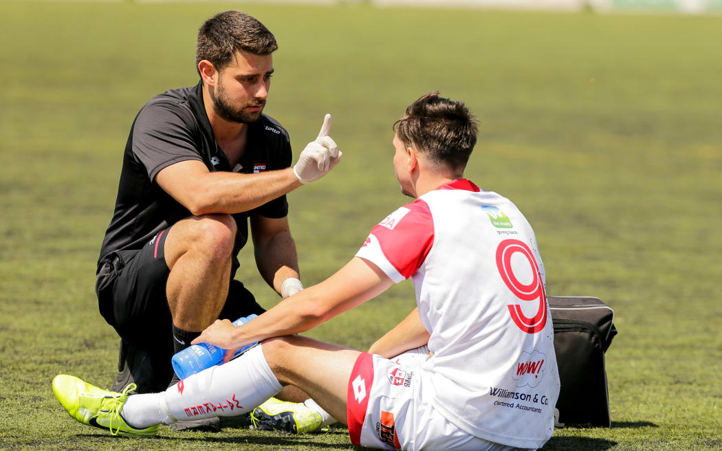 Waitakere United's Dane Schnell is checked for concussion.