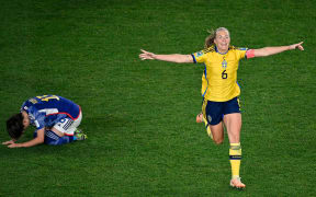 Sweden's Magdalena Eriksson celebrates Sweden’s win as Japan's Aoba Fujino is dejected following their FIFA World Cup quarter-final at Eden Park.