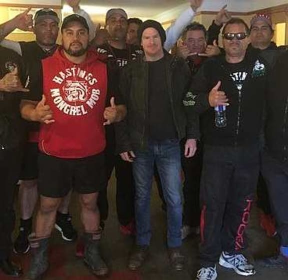 Gang expert and academic, Jarrod Gilbert. (centre) standing with group of men