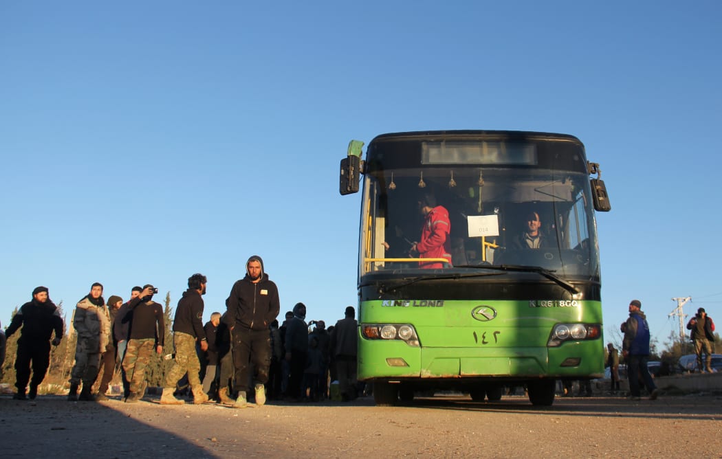 Evacuees from Aleppo arrive in the opposition-controlled Khan al-Aassal region, west of the city on 15 December.