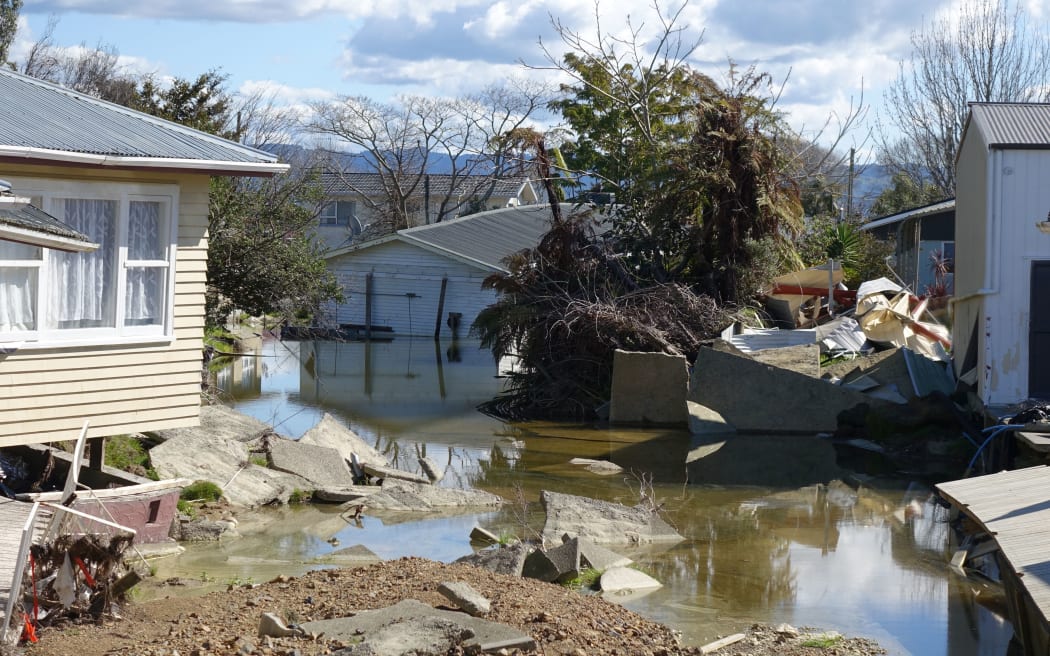 Houses on College Road that were devastated by the flood lie broken and abandoned.