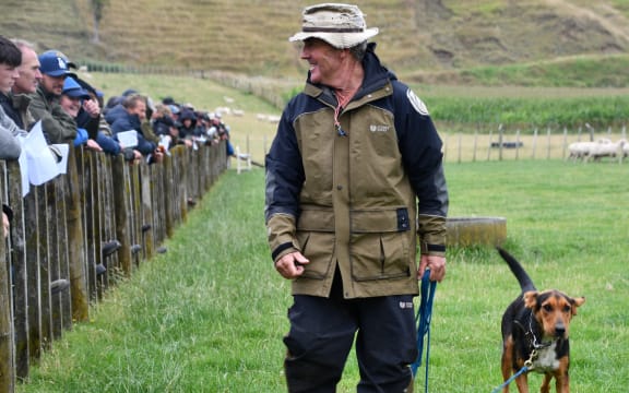 Jonathan Smailes shows his 11-month-old Wedge to the crowd at the Parapara-Makirikiri Sheep Dog Trial Club auction. She sold for $9800.