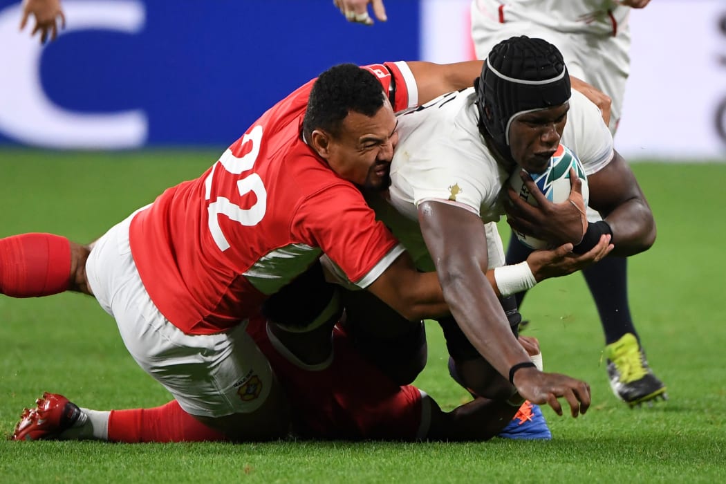 James Faiva tackles England lock Maro Itoje during Tonga's 2019 Rugby World Cup opener.