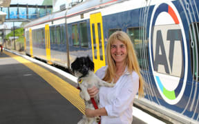 Councillor Cathy Casey with her dog Suzie on the train station platform.