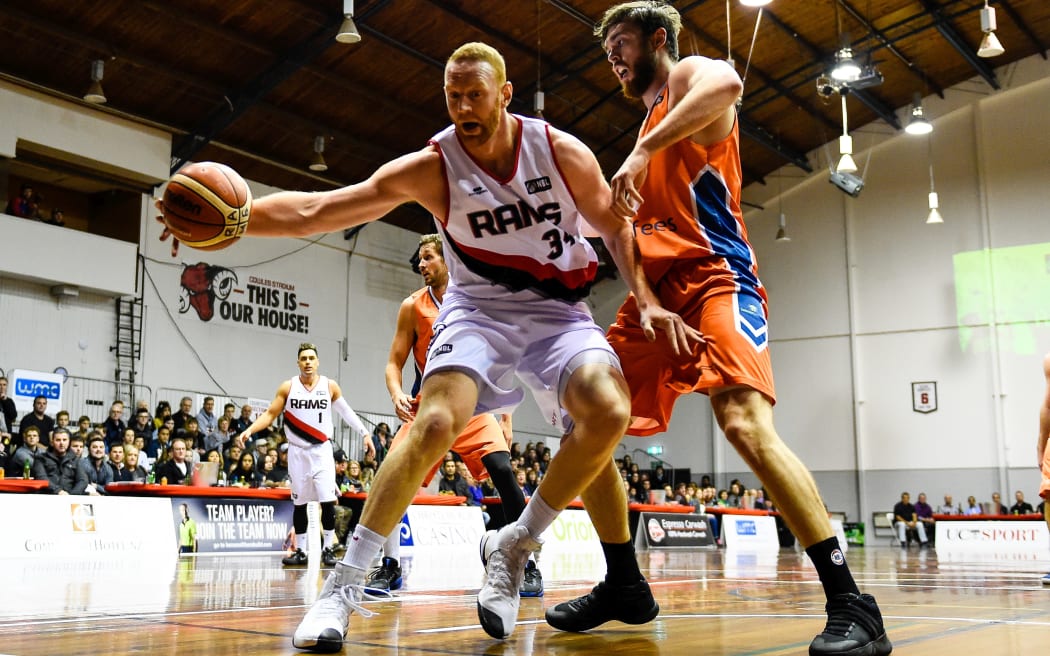 Gareth Dawson of the Rams steals the ball from Nicholas Kay of the Southland Sharks.