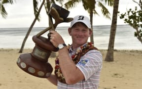 Brandt Snedeker on the beach with the Fiji International trophy.