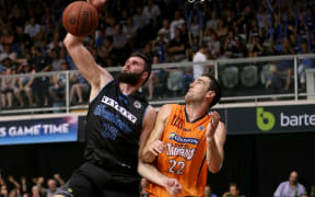 Breakers' Alex Pledger beats Taipans' Matthew Burston to score.