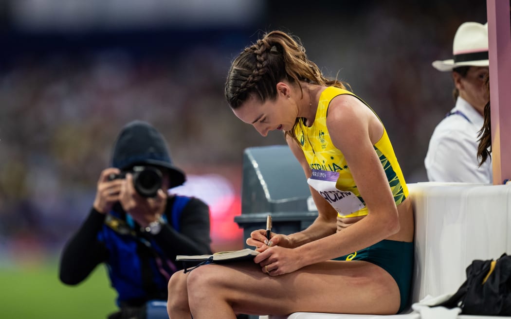 PARIS, FRANCE - AUGUST 4: Nicola Olyslagers of Team Australia writes something in a book during the Women's High Jump Final on day nine of the Olympic Games Paris 2024 at Stade de France on August 4, 2024 in Paris, France. (Photo by Kevin Voigt/GettyImages)