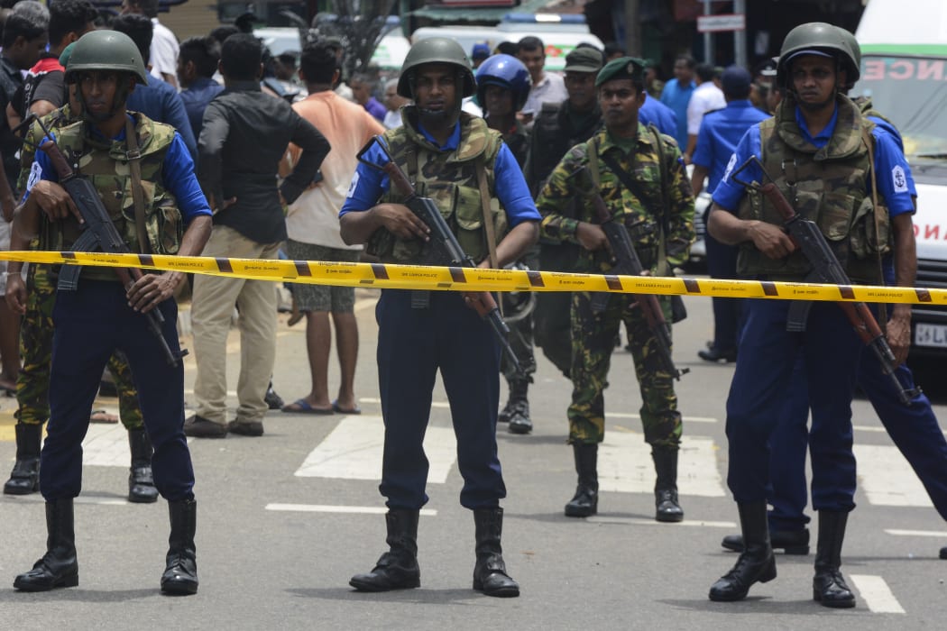 Sri Lankan military officers stand guard in front of St Anthony's Church where an explosion took place in Kochchikade, Colombo, Sri Lanka, on Easter Sunday, April 21, 2019.
