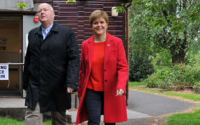 First Minister of Scotland and Scottish National Party (SNP) leader Nicola Sturgeon (R) leaves with her husband Peter Murrell (L), Chief Executive of the SNP, after voting in the European Parliament elections at Broomhouse Community Hall in Glasgow on May 23, 2019. Voting got under way in Britain early on Thursday in elections to the European Parliament -- a contest the country had not expected to hold nearly three years after the Brexit referendum. (Photo by Andy Buchanan / AFP)
