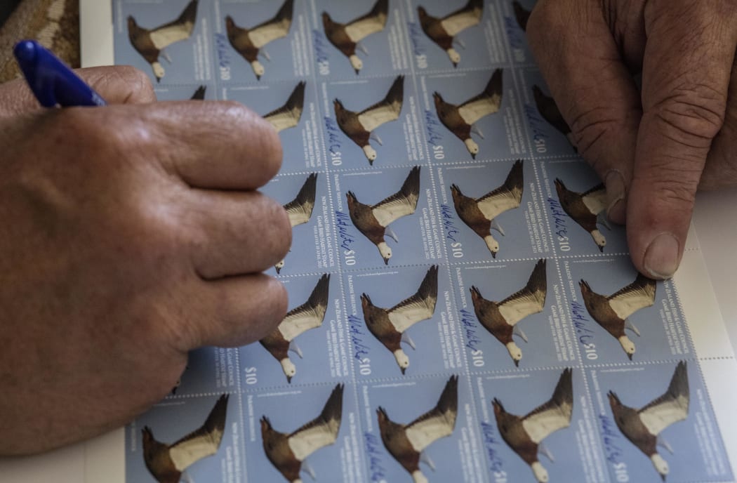 Matt Winter signing stamps made from his photograph.