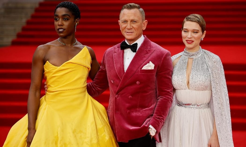 English actor Lashana Lynch (L), English actor Daniel Craig (C) and French actor Lea Seydoux pose on the red carpet after arriving to attend the World Premiere of the James Bond 007 film "No Time to Die"