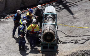 Members of a mine rescue crew working on the gag machine, used to extract gases, near the Pike River Mine access portal in 2010.
