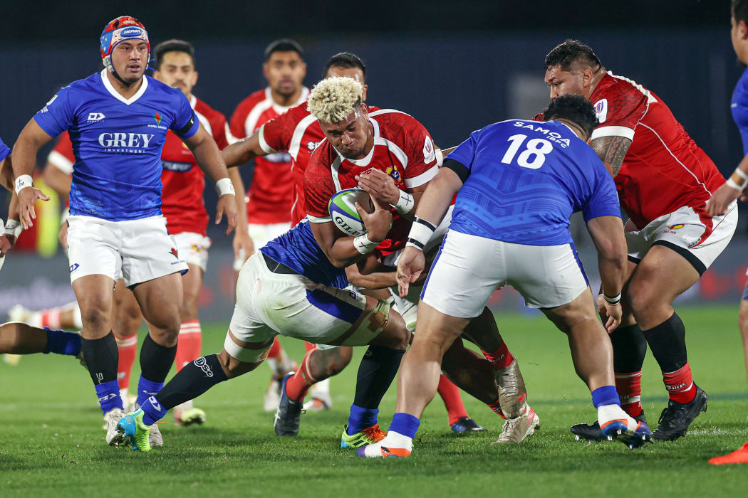 Tonga's Viliami Taulani is tackled during the first test against Samoa in Auckland.