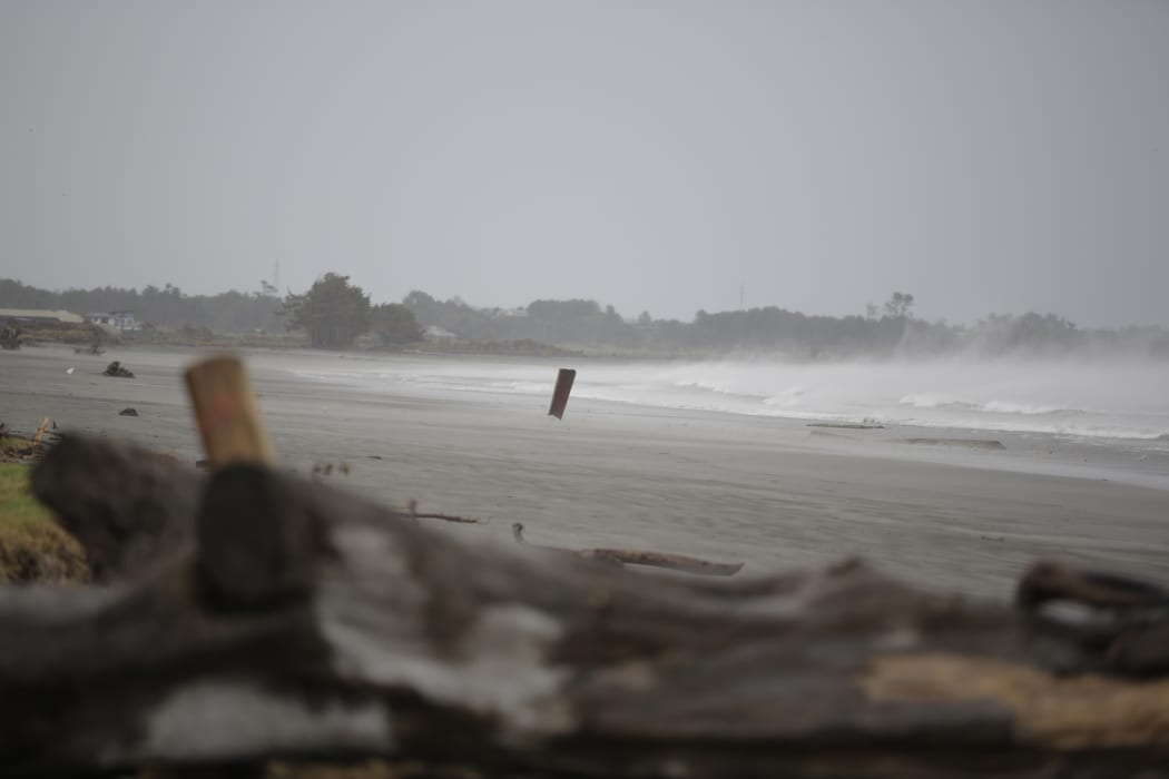 Buller district has declared a State of Emergency. Corrigated iron flys onto the beach in severe gales.