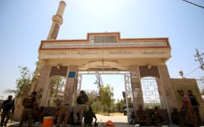 Iraqi government forces are seen in Fallujah, 50 kilometres (30 miles) from the capital Baghdad, after they retook the embattled city from the Islamic State group on June 26, 2016. I