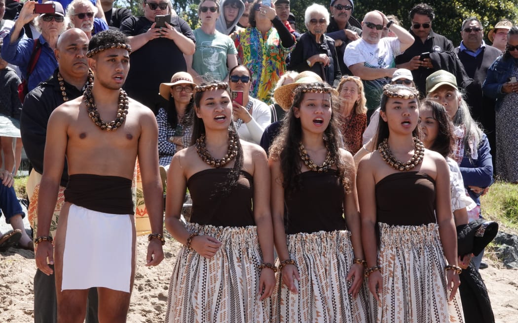 Members of the Hawaiian youth development group Papahana Aloha ‘Āina Hawai’i perform as the sailors are welcomed onto shore.