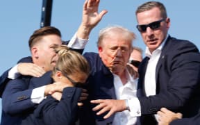 BUTLER, PENNSYLVANIA - JULY 13: Republican presidential candidate former President Donald Trump is rushed offstage during a rally on July 13, 2024 in Butler, Pennsylvania.   Anna Moneymaker/Getty Images/AFP (Photo by Anna Moneymaker / GETTY IMAGES NORTH AMERICA / Getty Images via AFP)