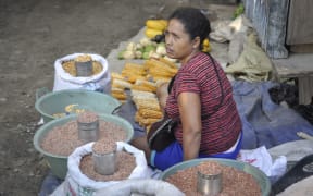 A vendor sells goods at a market in the Timor Leste capital Dili, in, 2013.