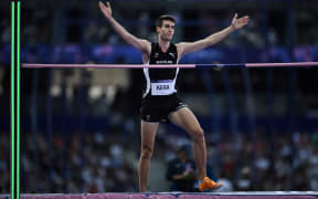 New Zealand's Hamish Kerr reacts as he competes in the men's high jump qualification of the athletics event at the Paris 2024 Olympic Games at Stade de France in Saint-Denis, north of Paris, on August 7, 2024. (Photo by Ben STANSALL / AFP)