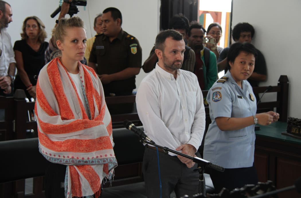 French journalists Valentine Bourrat and Thomas Dandois accompanied by an interpreter, face trial before a court in Jayapura in Indonesia's eastern Papua province.