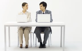 Office workers sitting by side.