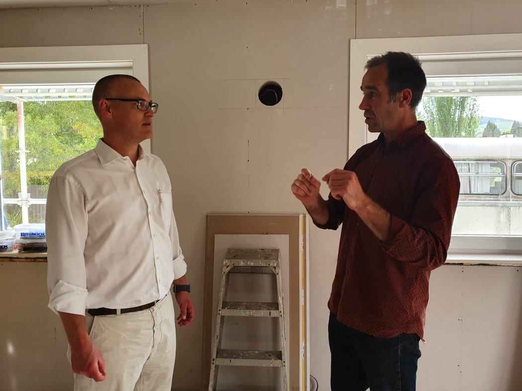 Blueskin Resilient Communities Trust manager Scott Willis speaks to the Minister for Health, David Clark, during a visit to the house.