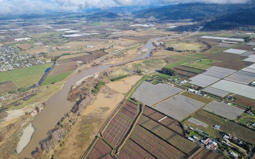 The Motueka River after flooding in the Tasman region in June 2025, with orchards visible on the right hand side.
