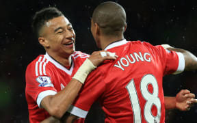 Ashley Young of Man Utd celebrates with teammate Jesse Lingard.