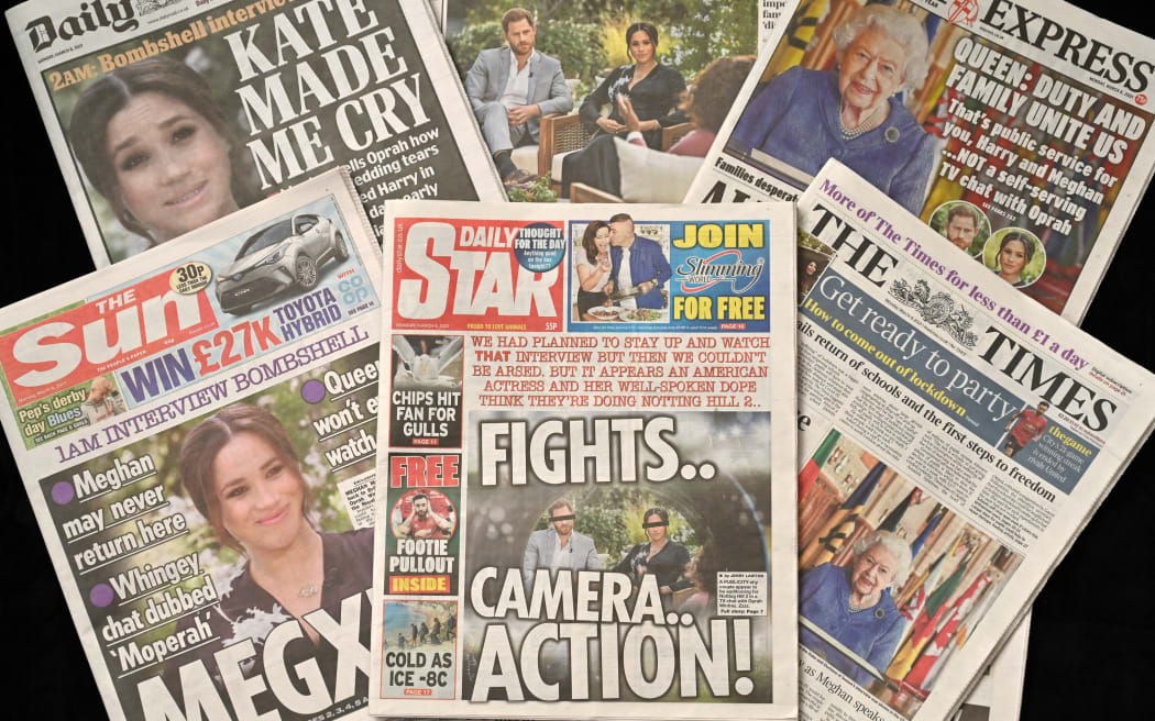 An arrangement of UK daily newspapers photographed as an illustration, shows front page headlines reporting on the story of the interview given by Meghan, Duchess of Sussex, wife of Britain's Prince Harry, Duke of Sussex, to Oprah Winfrey, which aired on US broadcaster CBS.