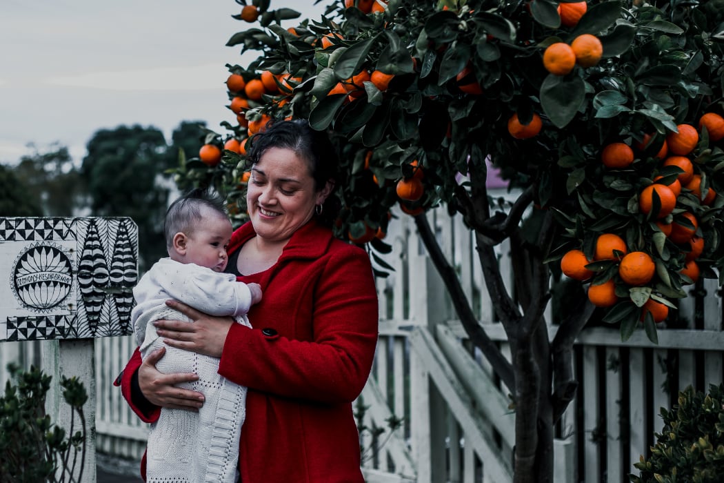 Kesaia Walker holding her baby Raita.