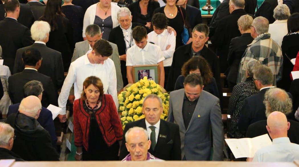 Pallbearers remove Jim Anderton's casket following the requiem.