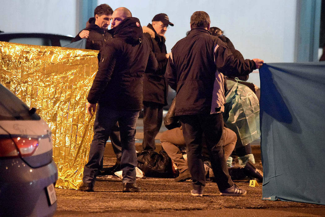 Italian police and forensics experts gather around the body of suspected Berlin truck attacker Anis Amri after he was shot dead in Milan.