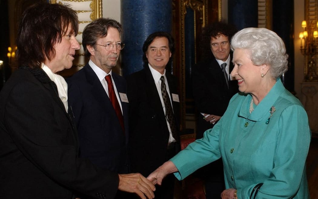 Queen Elizabeth II meets legendary guitarists Jeff Beck, Eric Clapton, Jimmy Page  and Brian May during a reception at Buckingham Palace in 2005.