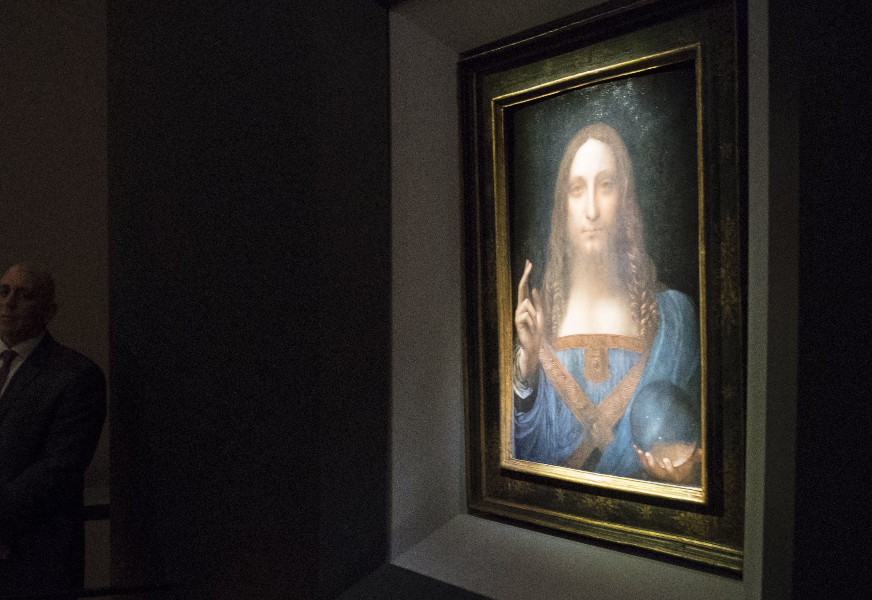 Visitors view the painting 'Salvator Mundi' by Leonardo da Vinci at Christie's New York Auction House.