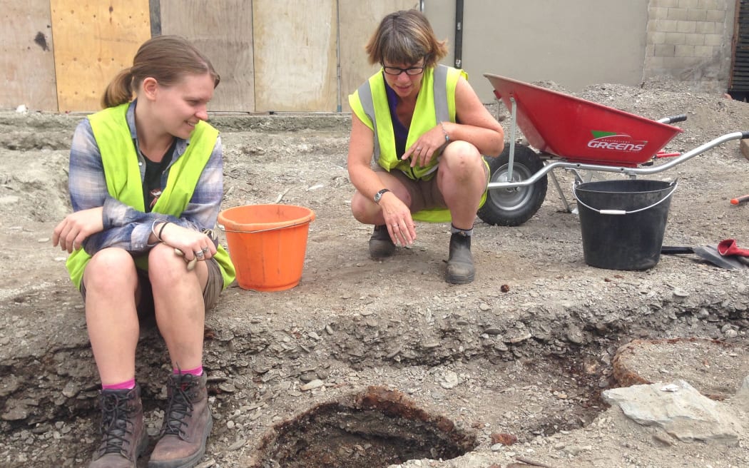 Archaeological PHD student Naomi Woods (left) and Dr Andrea Farminer study a trench containing six barrel hoops, which may be the former Eichardt's Hotel toilets.