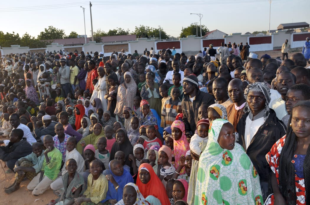 Displaced people from Baga listens to President Goodluck Jonathan (unseen) in a Maiduguri camp on 15 January.