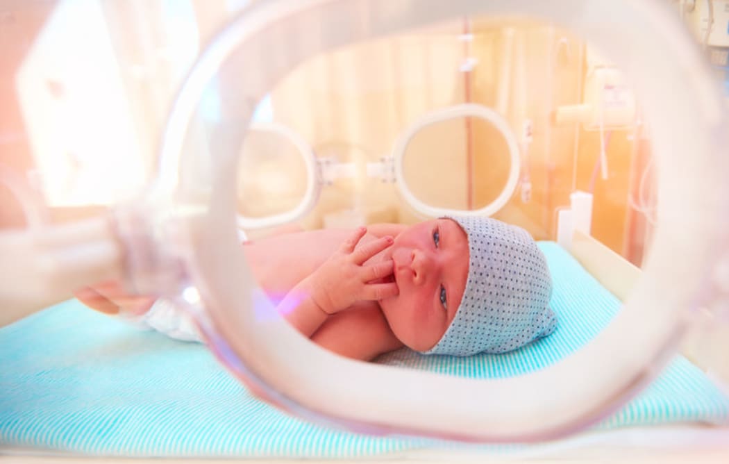 A premature baby in an incubator.