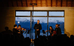 Baritone Julien Van Mellaerts and string quartet perform on stage in Rippon Hall.
