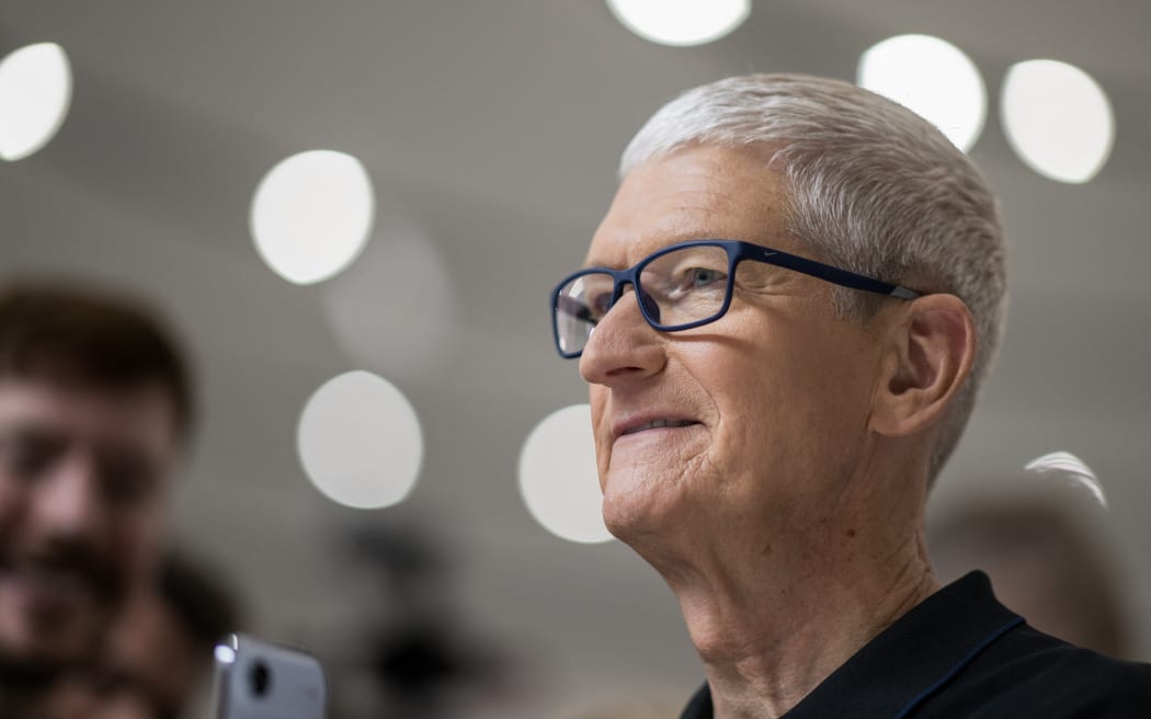 Apple CEO Tim Cook looks at new products during Apple's "Awe-Dropping" event at the Steve Jobs Theater on the Apple Park campus in Cupertino, California, on September 9, 2025. (Photo by Nic Coury / AFP)