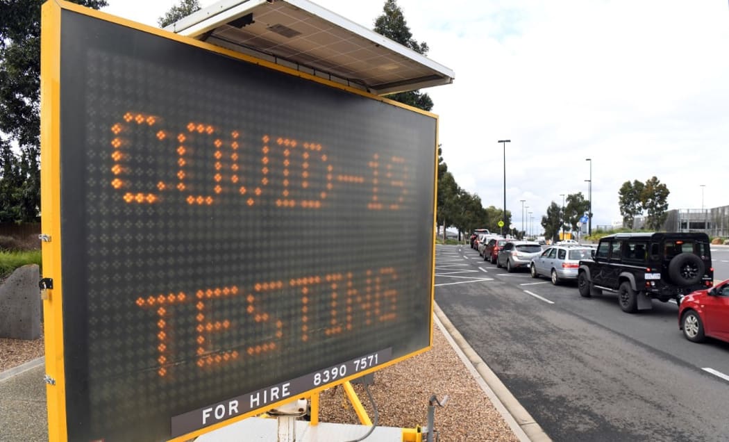 A long queue of cars wait at a drive-through COVID-19 testing site located in a shopping centre carpark in Melbourne.