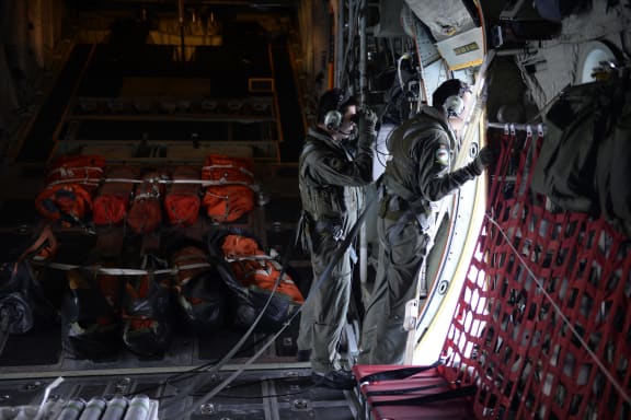 Searchers scanning the sea from a Singapore Air Force plane.