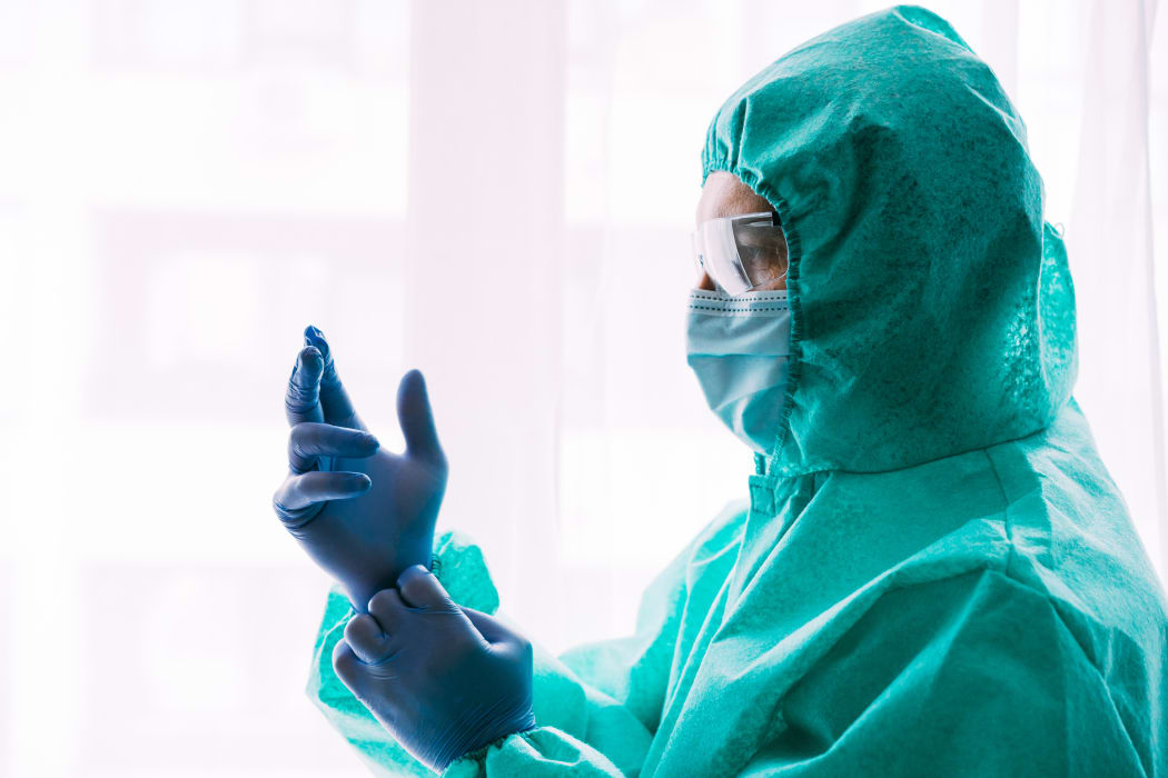 Man doctor or scientist waring protective suit, and face mask