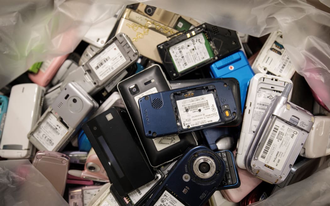In this picture taken on February 18, 2019, a pile of used mobile phones collected by the Tokyo Organising Committee of the Olympic and Paralympic Games is seen at the Tokyo Metropolitan Government building in Tokyo, as part of Tokyo 2020 Medal Project.