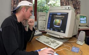 Computer technician Colin Jones puts the finishing touches to his "2000-Live" website in Gisborne 30 November 1999 which will broadcast on-line (www.2000-Live.com) the dawn of the new millennium via five remote-controlled video cameras.